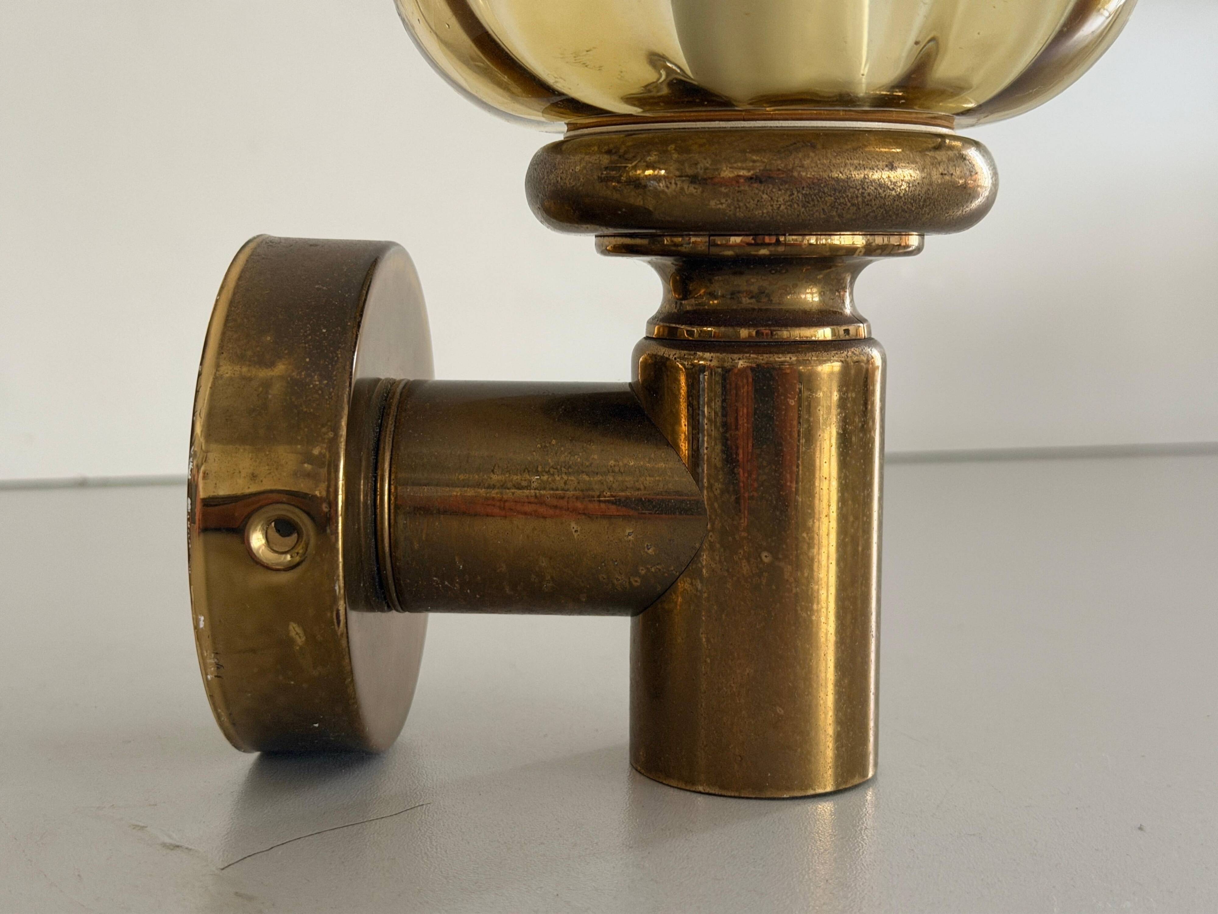 Pair of yellow glass and brass wall lights from the mid-century by N Leuchten, 1960s, Germany.