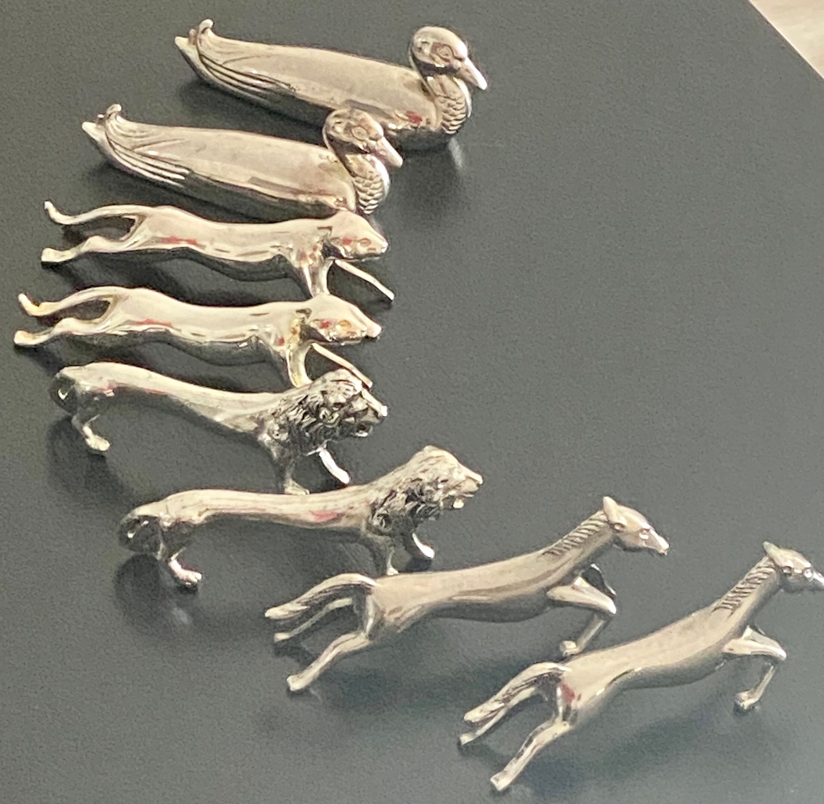 8 various animal knife holders in silver metal