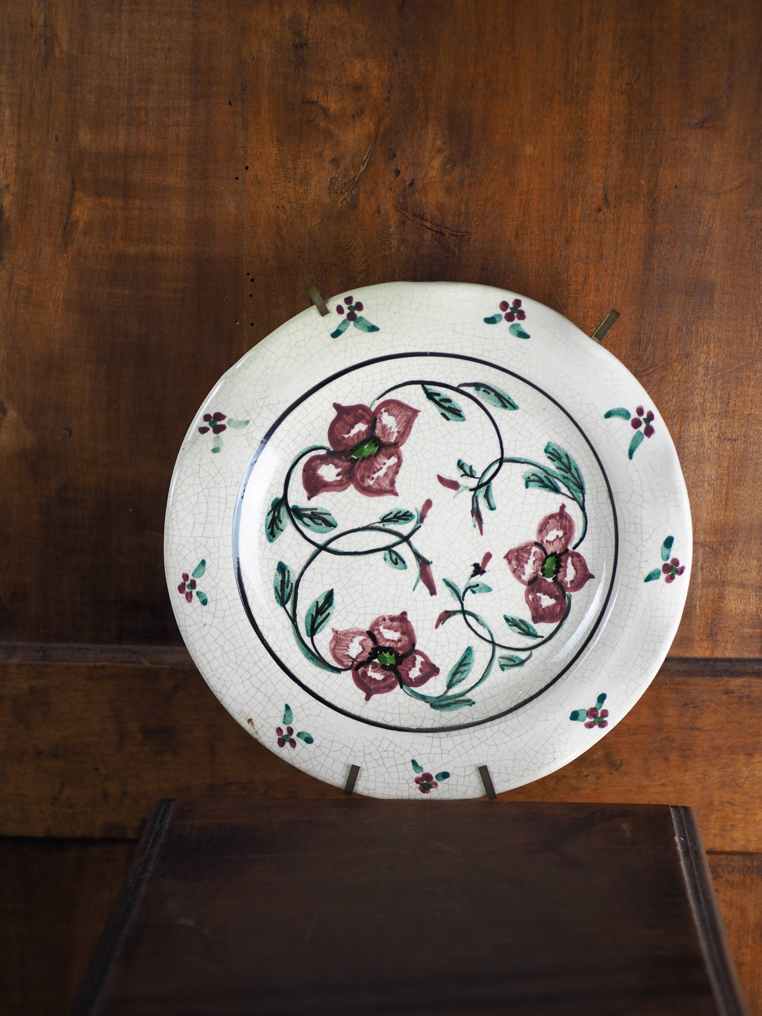 Meyssac plate decorated with flowers on cracked background early twentieth century and its support