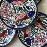 4 colorful flat plates with a fish pattern