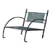 Low armchair in hammered wrought iron, France, circa 1960.
