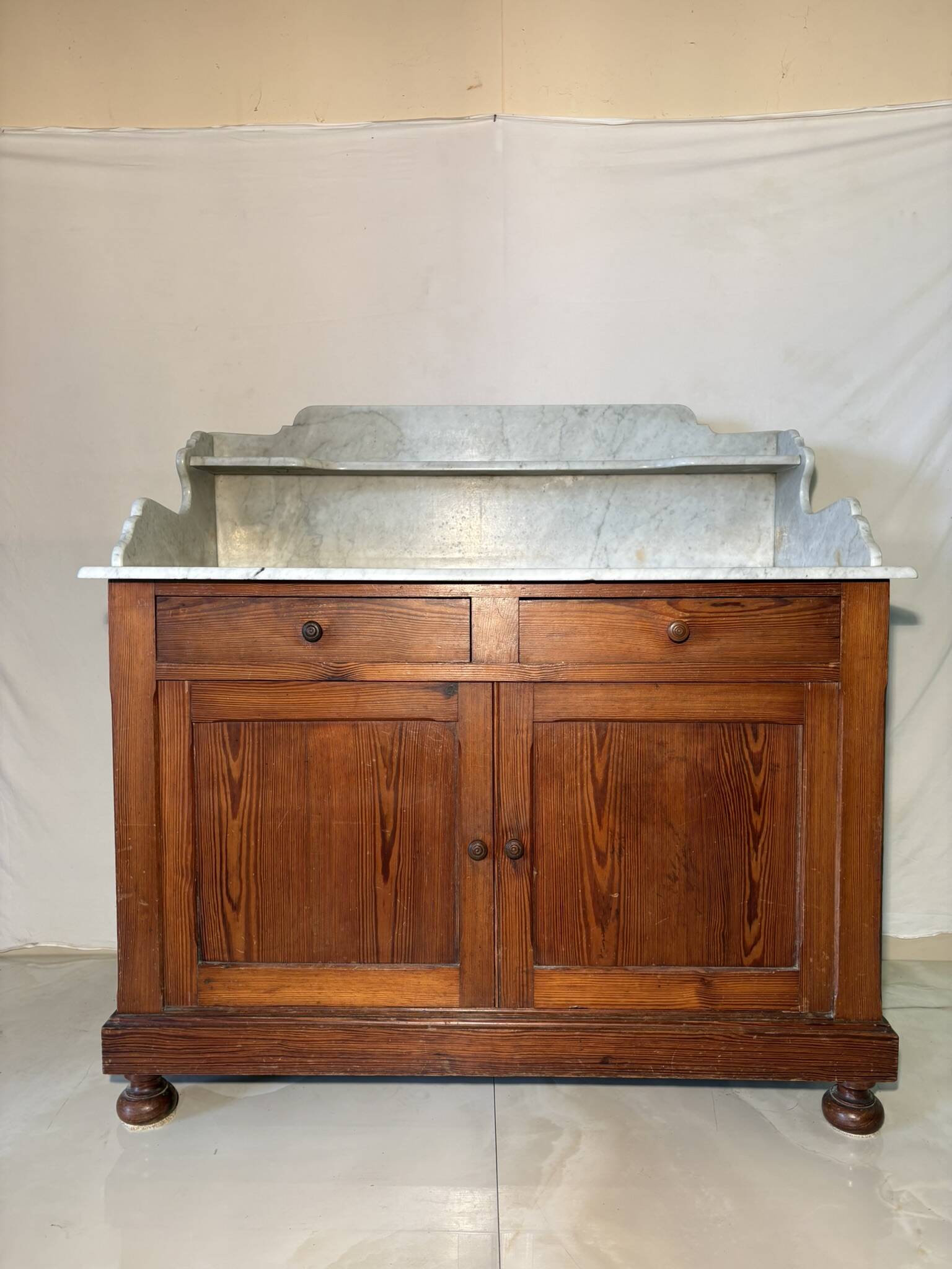 Antique wood and marble kitchen sideboard with carved backsplash