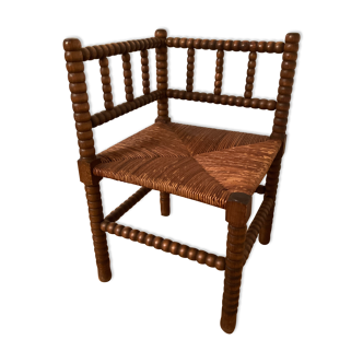 Old corner chair in oak wood, sitting in cannage