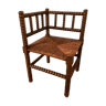 Old corner chair in oak wood, sitting in cannage