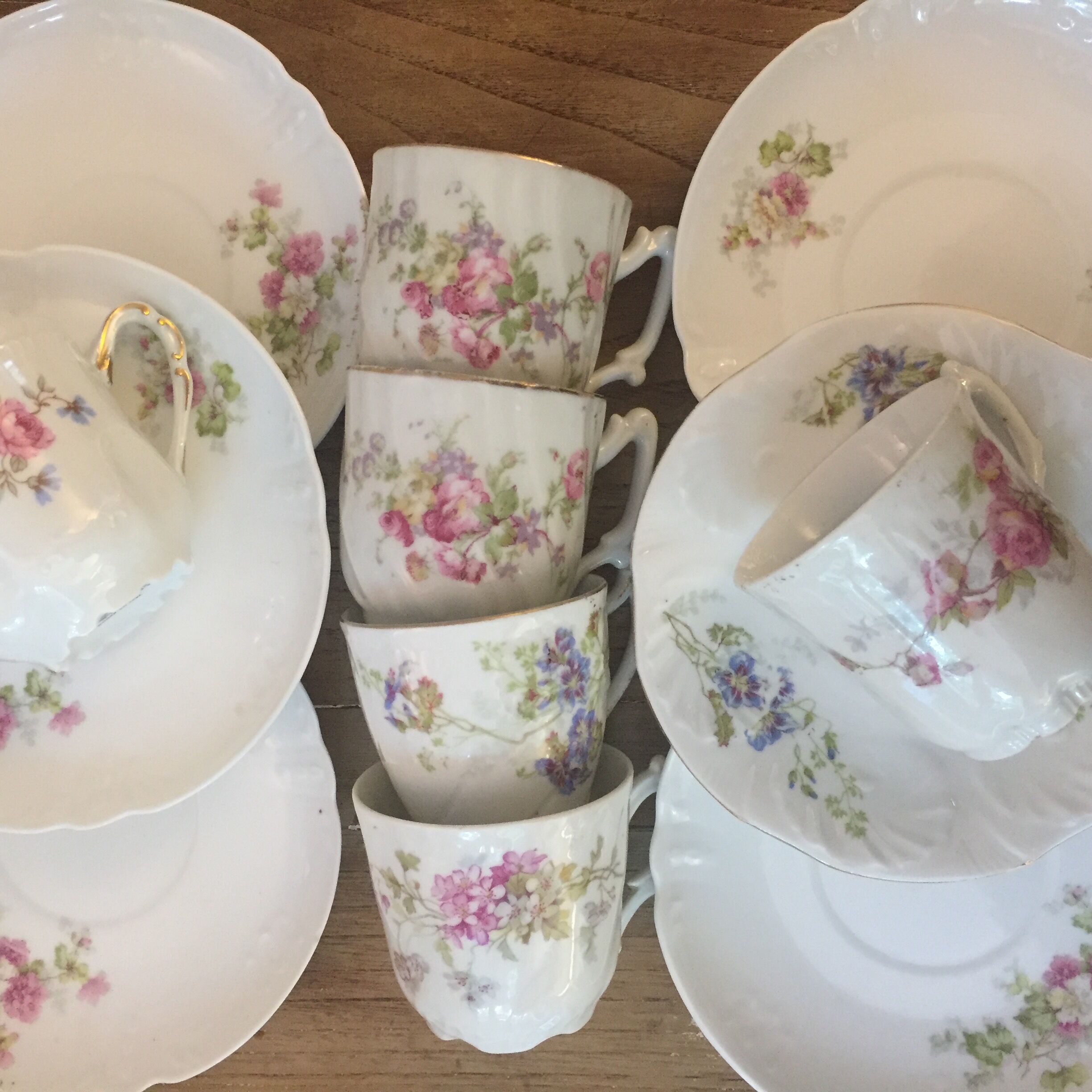 6 antique cups and mismatched saucers