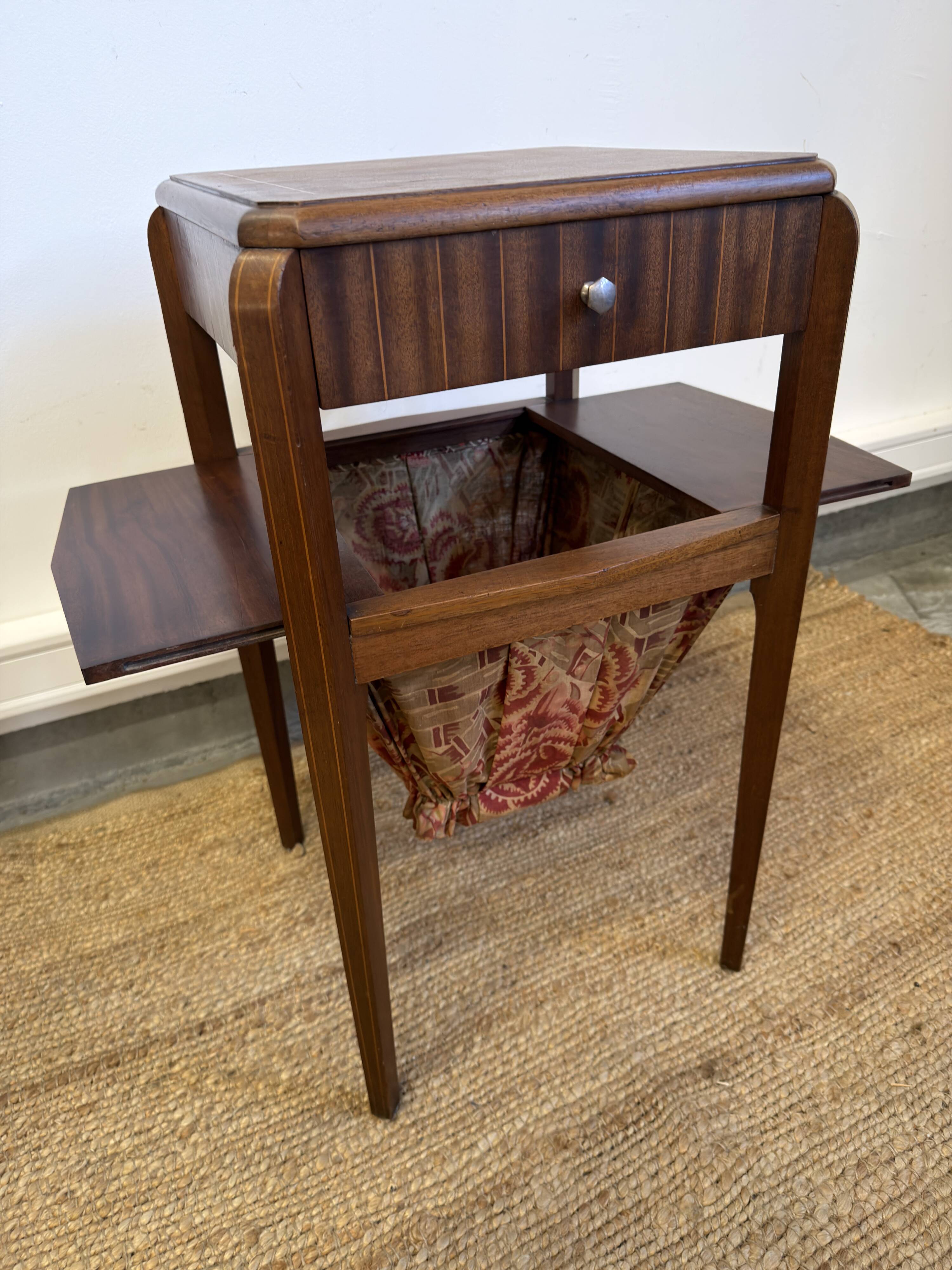 Art Deco sewing table in walnut with a foldable shelf.