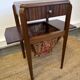Art Deco sewing table in walnut with a foldable shelf.