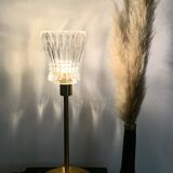 Table lamp with a crystal glass lampshade, like a vase and a golden base