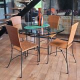 Glass and metal table and its 4 wicker chairs and glass Roche Bobois