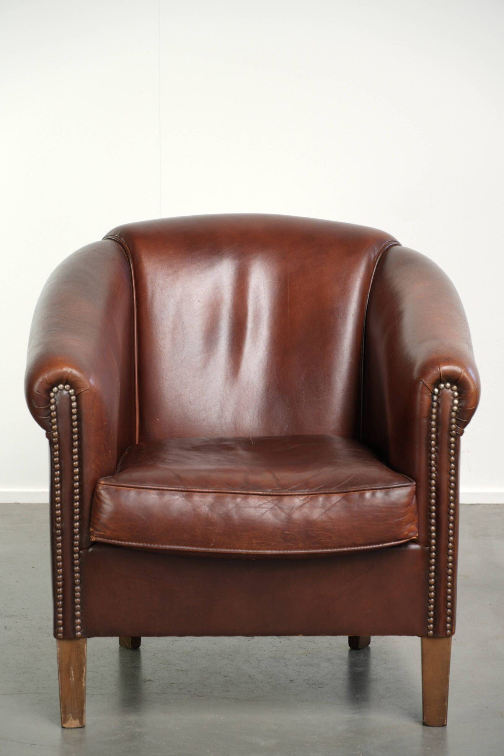 Sheepskin club armchair in English style with brown colour scheme
