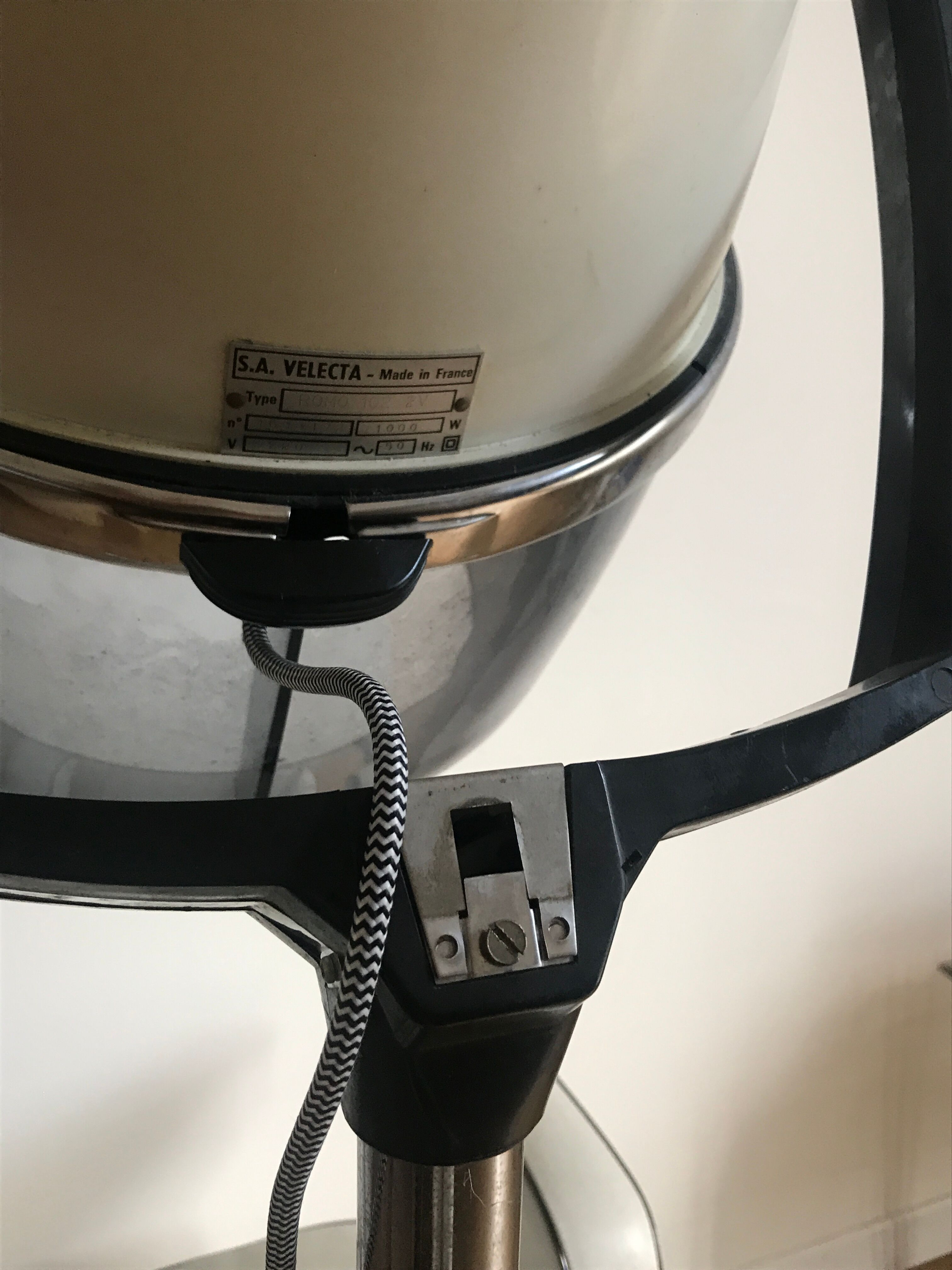 Vintage hairdresser's armchair with helmet transformed into a lamp