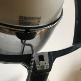 Vintage hairdresser's armchair with helmet transformed into a lamp