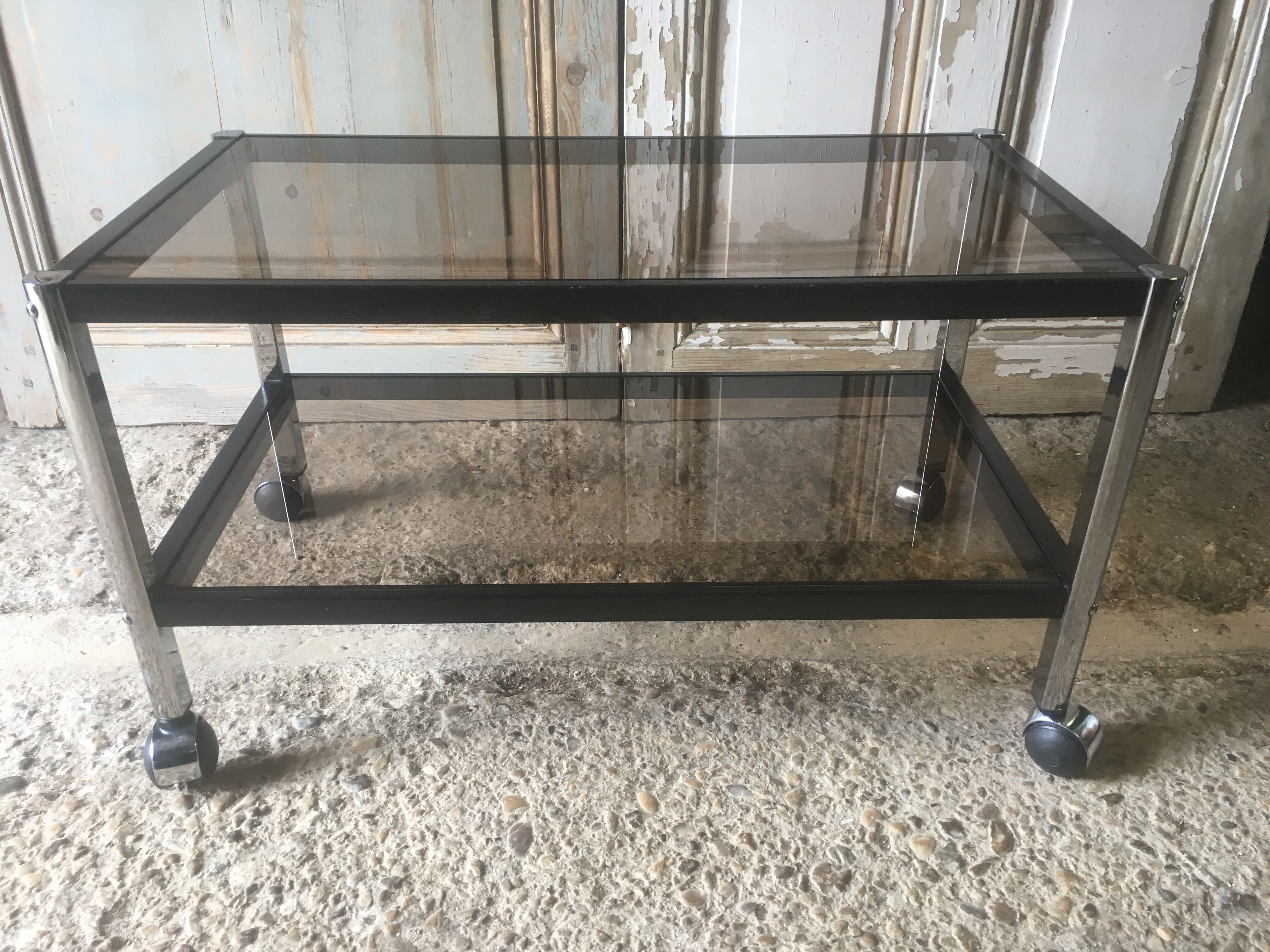 Metal coffee table with smoked glass.