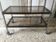 Coffee table in metal and smoked glass.
