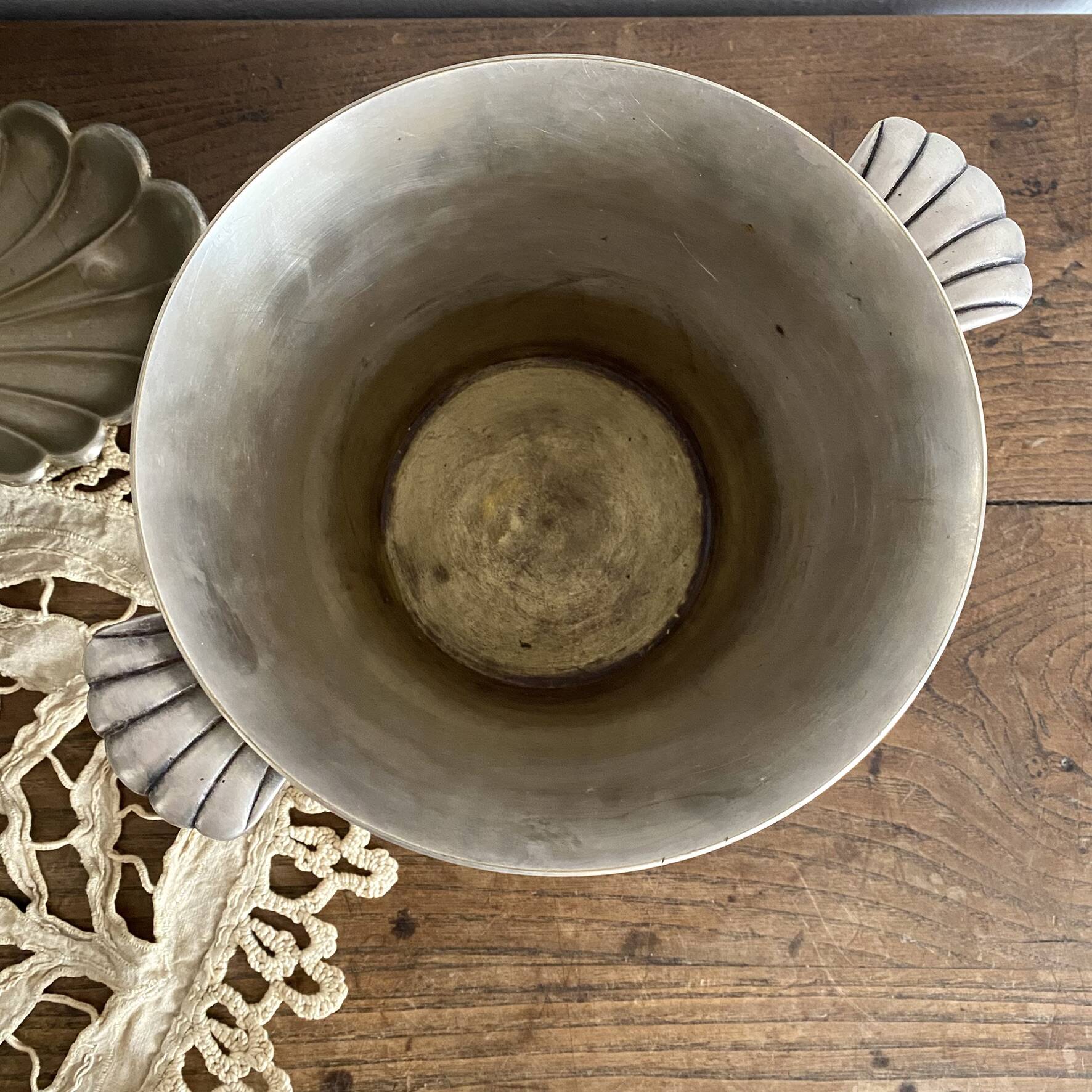 Antique champagne bucket with shell handles.