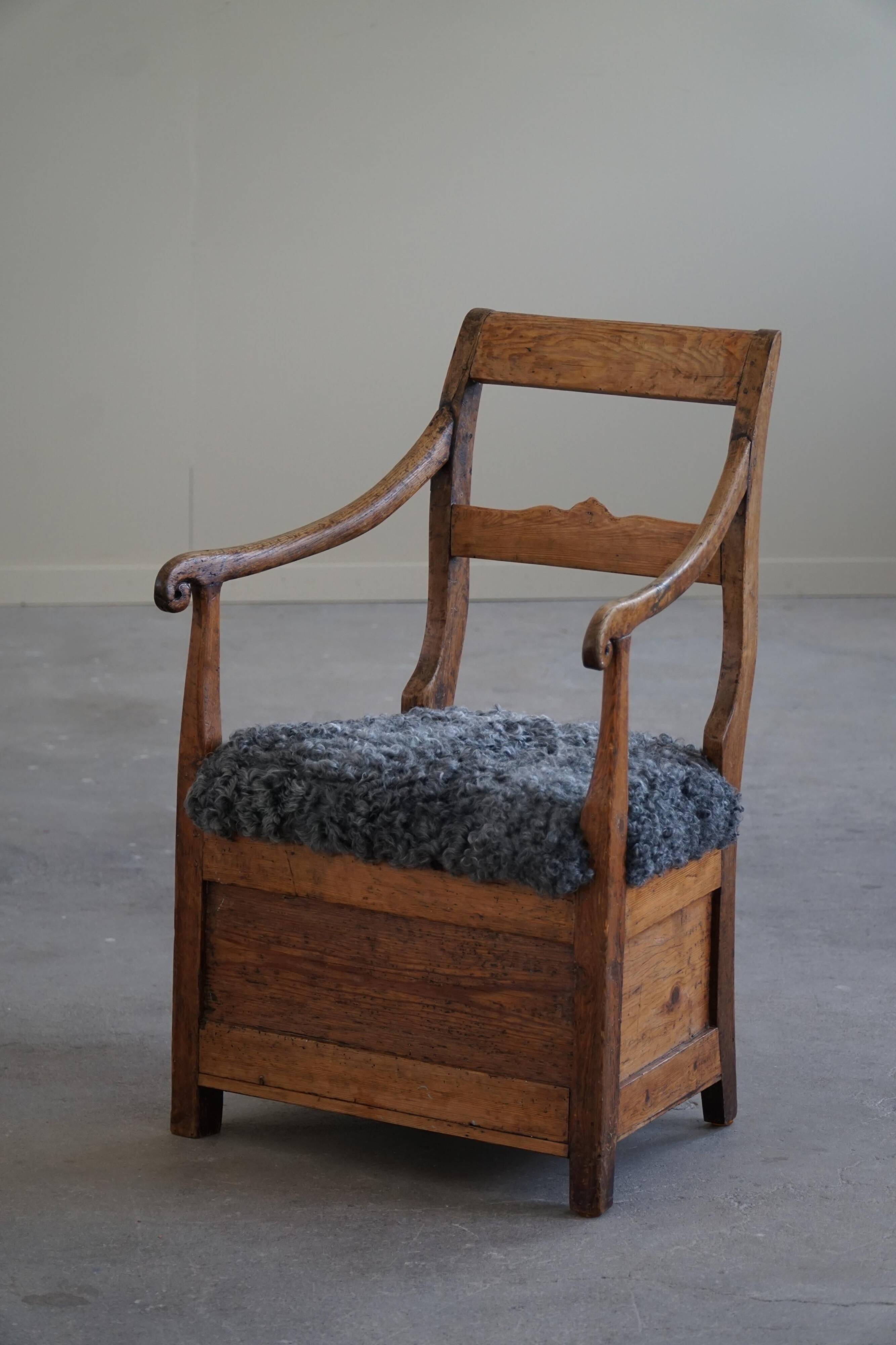Danish popular art armchair in solid oak and Gotland sheep skin, mid-19th century.