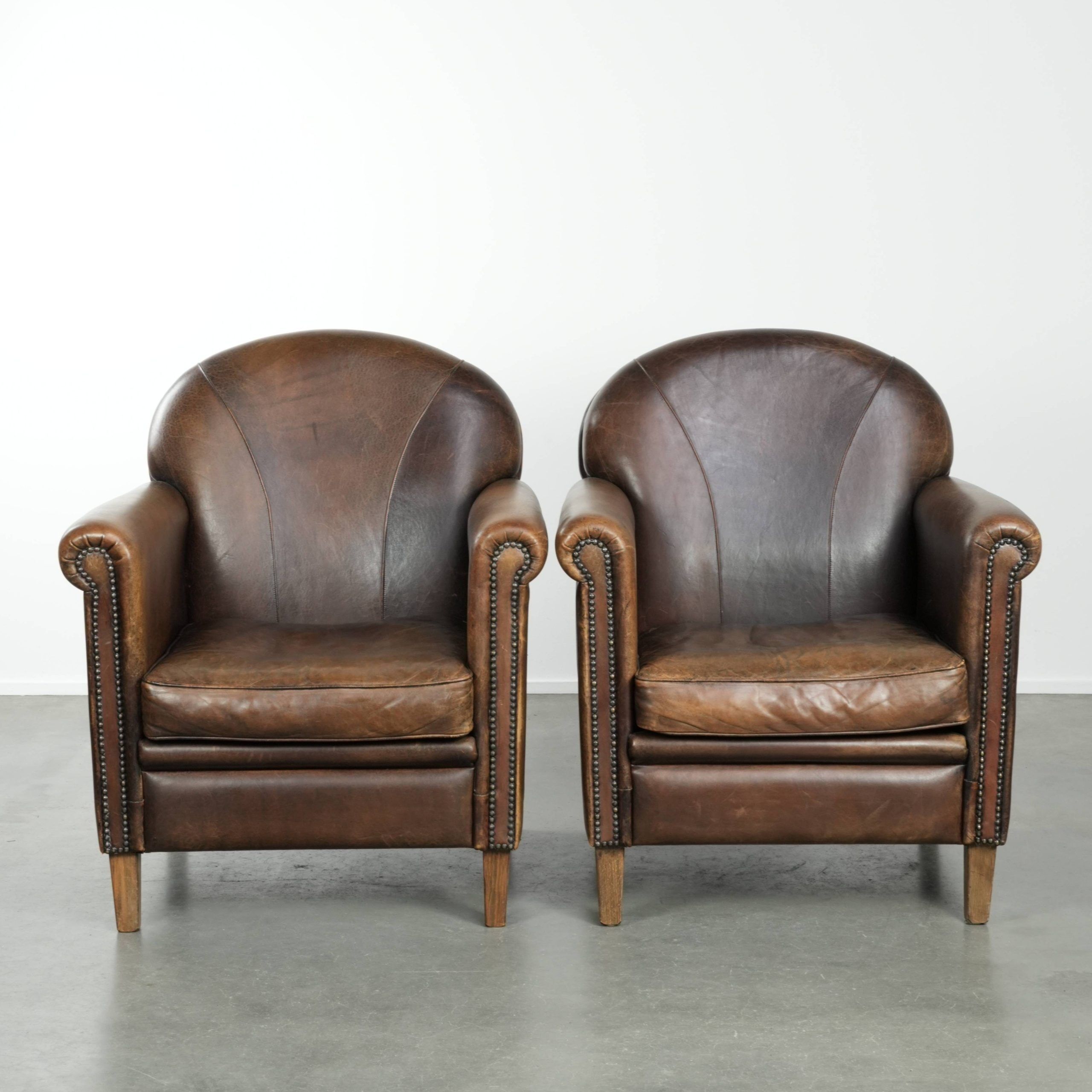Characterful set of two sheepskin design armchairs with beautiful patina