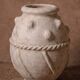 Glazed terracotta urn with protrusions and cordons.
