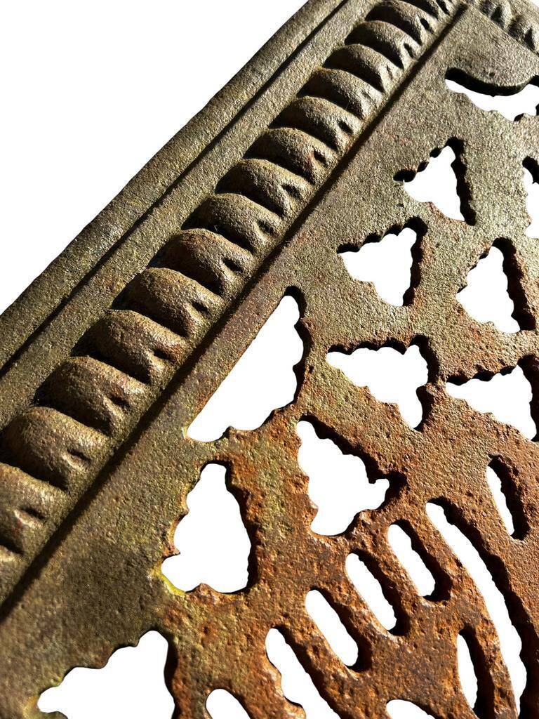 Antique cast iron garden table with decorative openwork top.