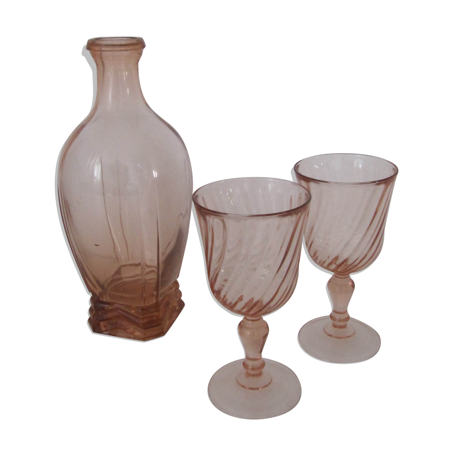 Old bottle in pink glass and 2 wine glasses