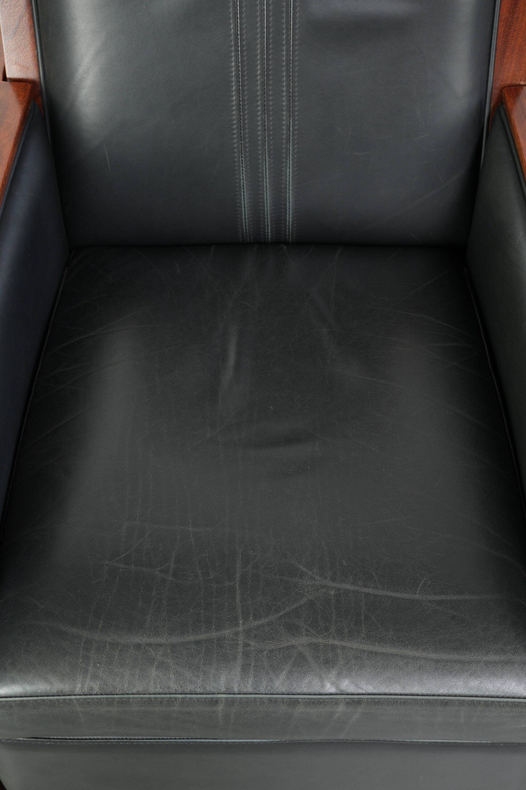 Electrically adjustable Art Deco design recliner with black cowhide leather