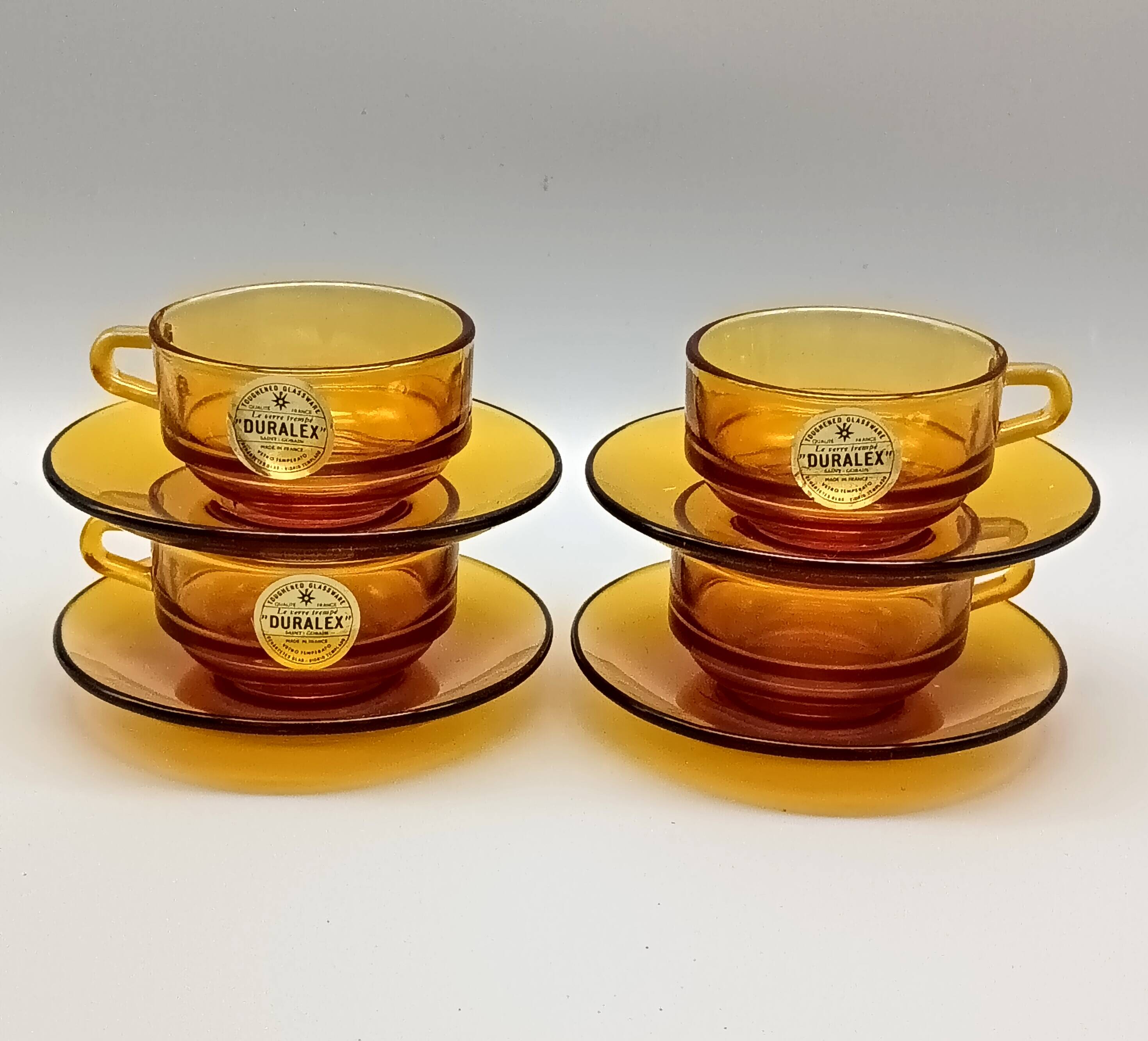 4 Duralex glass cups and saucers, amber color, France vintage