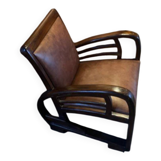 Vintage leather and teak armchair from the 1960s.