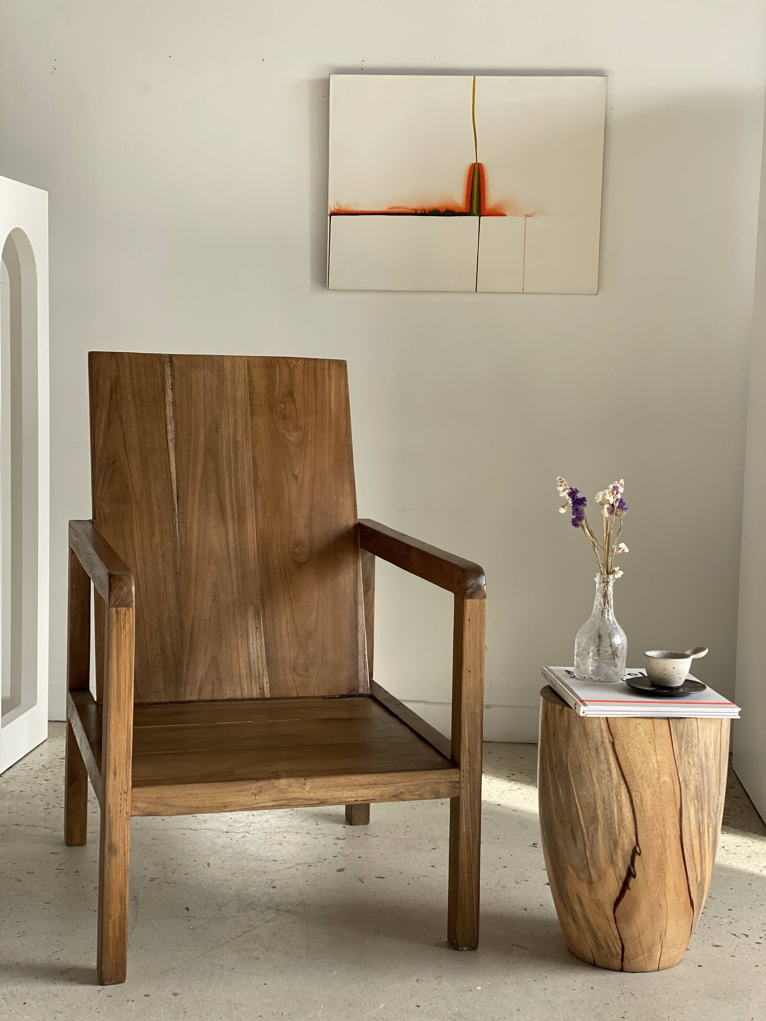 Large armchair in natural wood (teak) with a minimalist design.