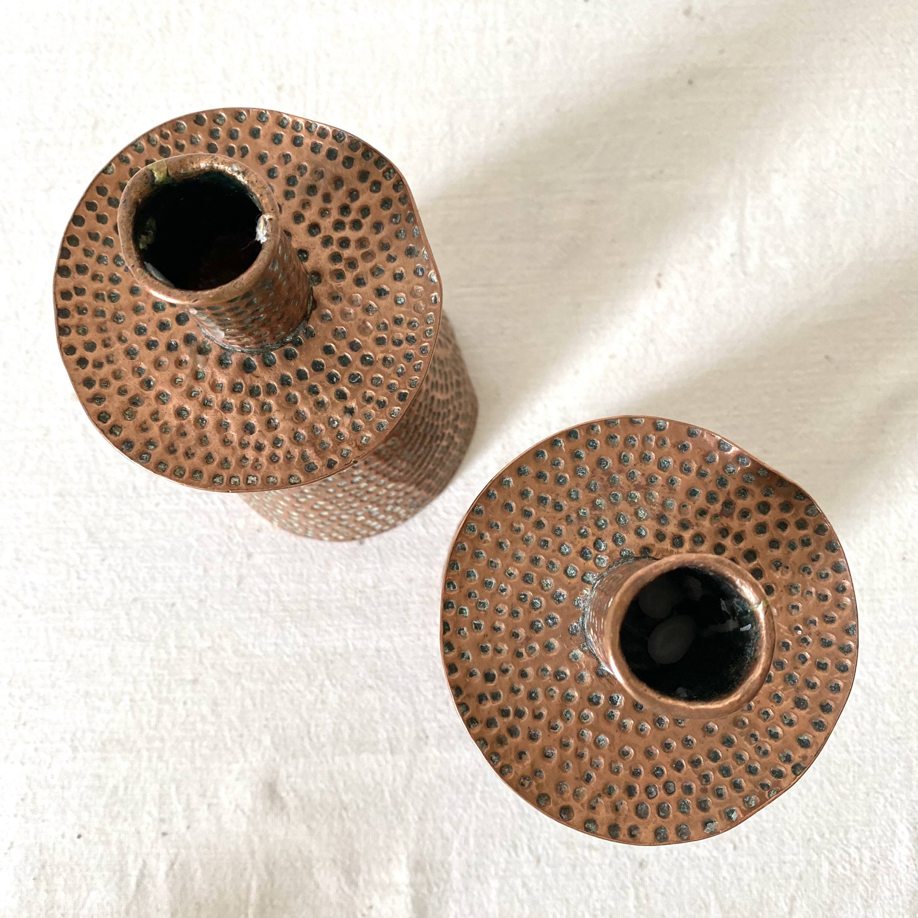 Pair of hammered copper candlesticks from the 1950s