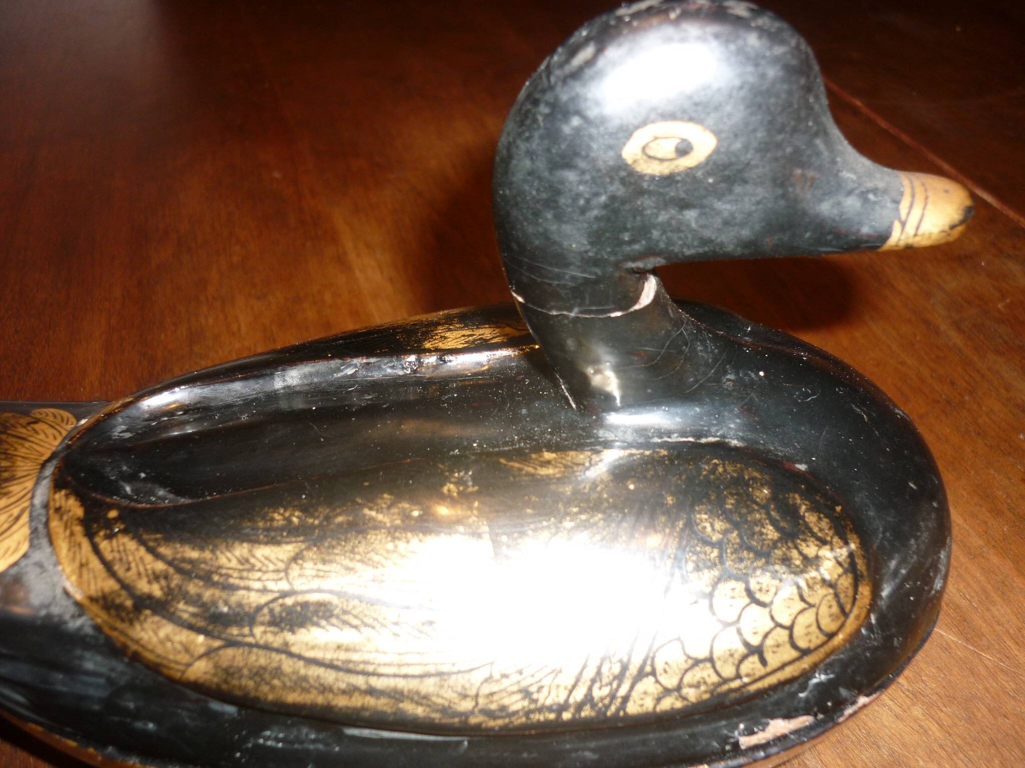 Black and gold wooden duck