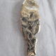 silver metal sugar and silver sugar spoon.