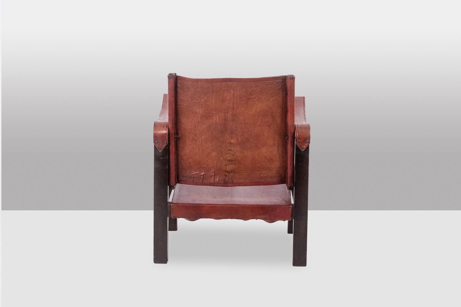 “Safari” armchair in wood and cognac leather. 1960s/70s.