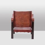“Safari” armchair in wood and cognac leather. 1960s/70s.