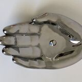 Empty silver chromed ceramic pocket in the shape of a large hand, 1980