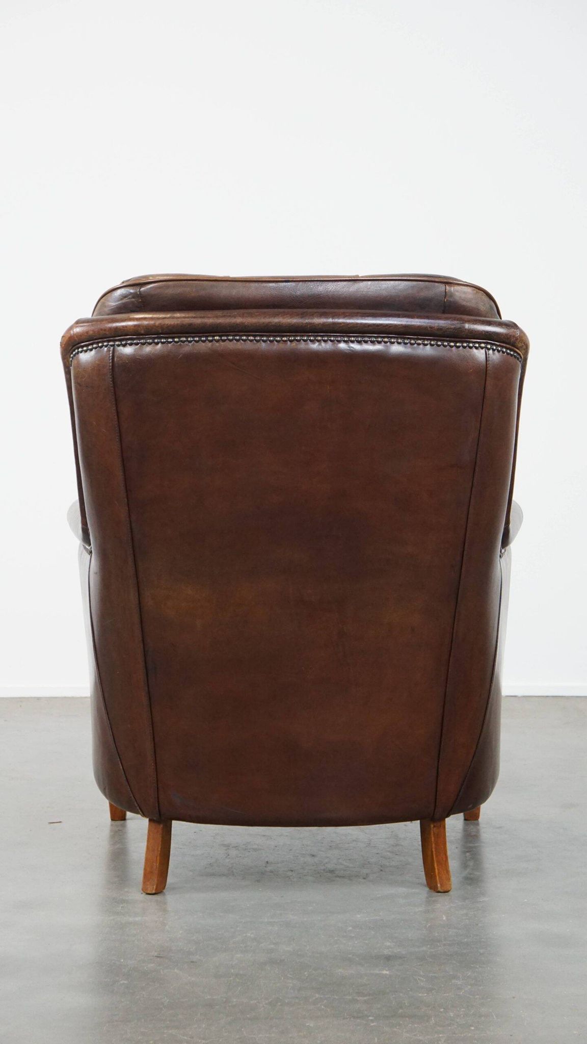 Vintage sheepskin armchair in a dark cognac colour with a comfortable seat