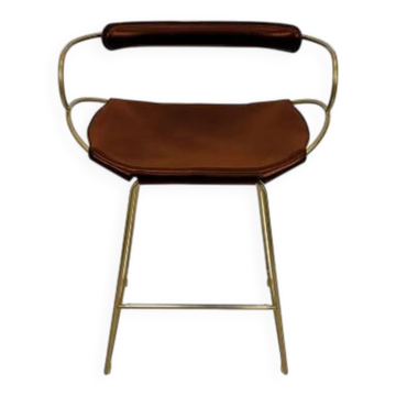 Contemporary sculptural bar stool with a metal back in aged brass and cognac leather.