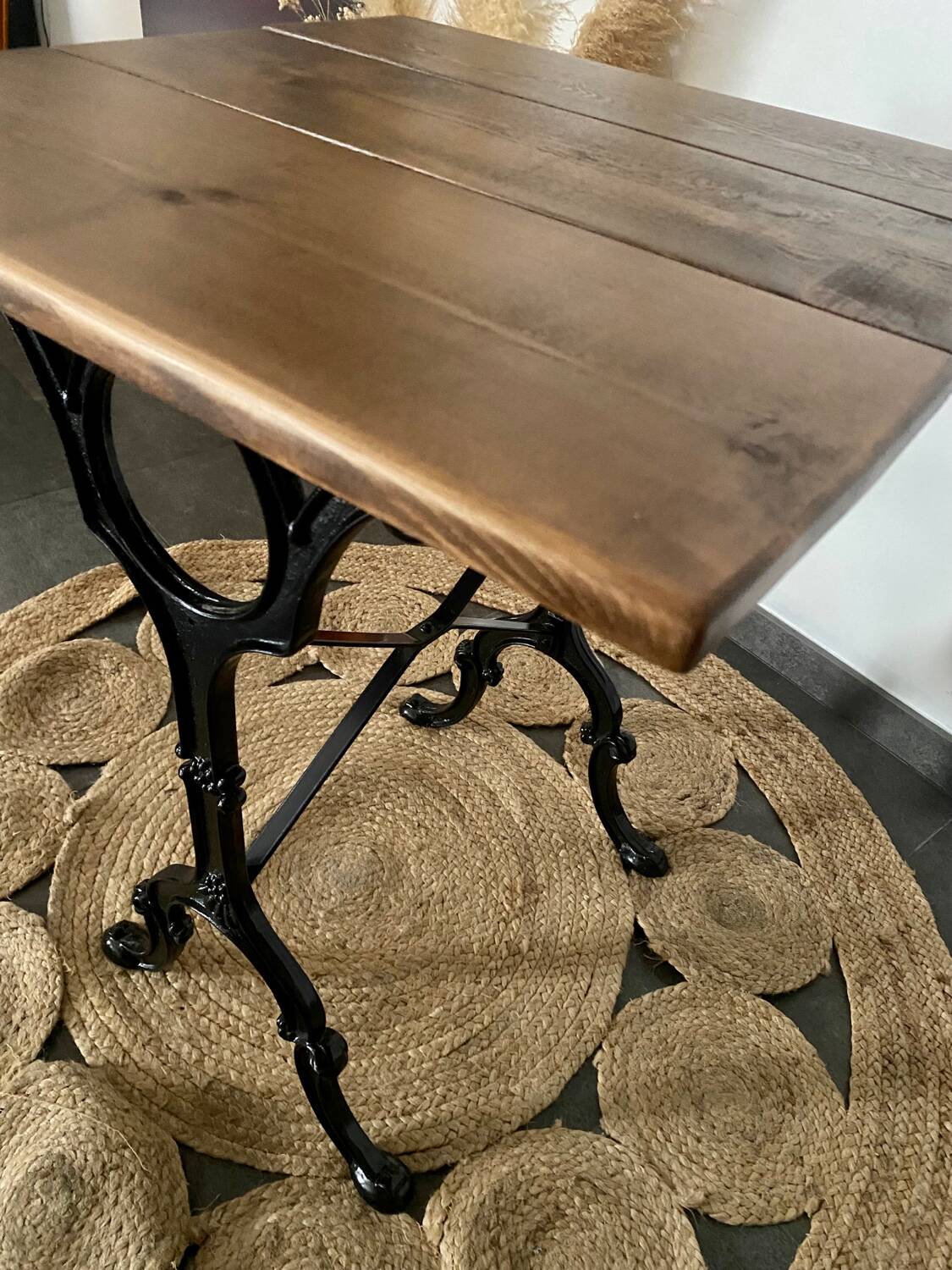 Bistro table with iron legs and raw wood top.