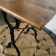 Bistro table with iron legs and raw wood top.