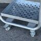 Four-wheeled dessert trolley with 4 perforated metal shelves.