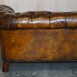 Victorian Chesterfield leather upholstered canapé with feather cushions.