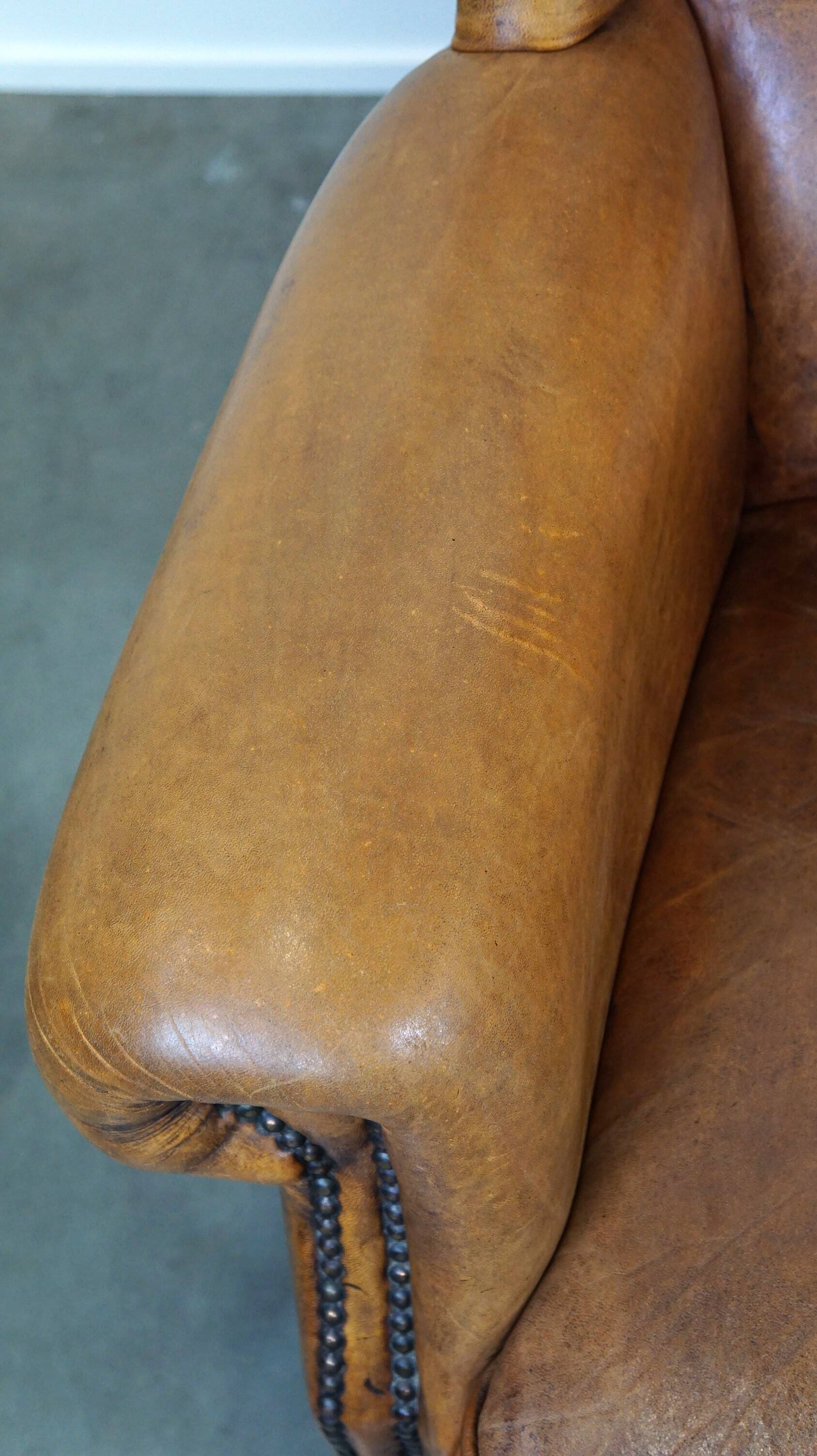 Set of 2 beautiful and correct sheep leather wingback armchairs with fixed seat cushions