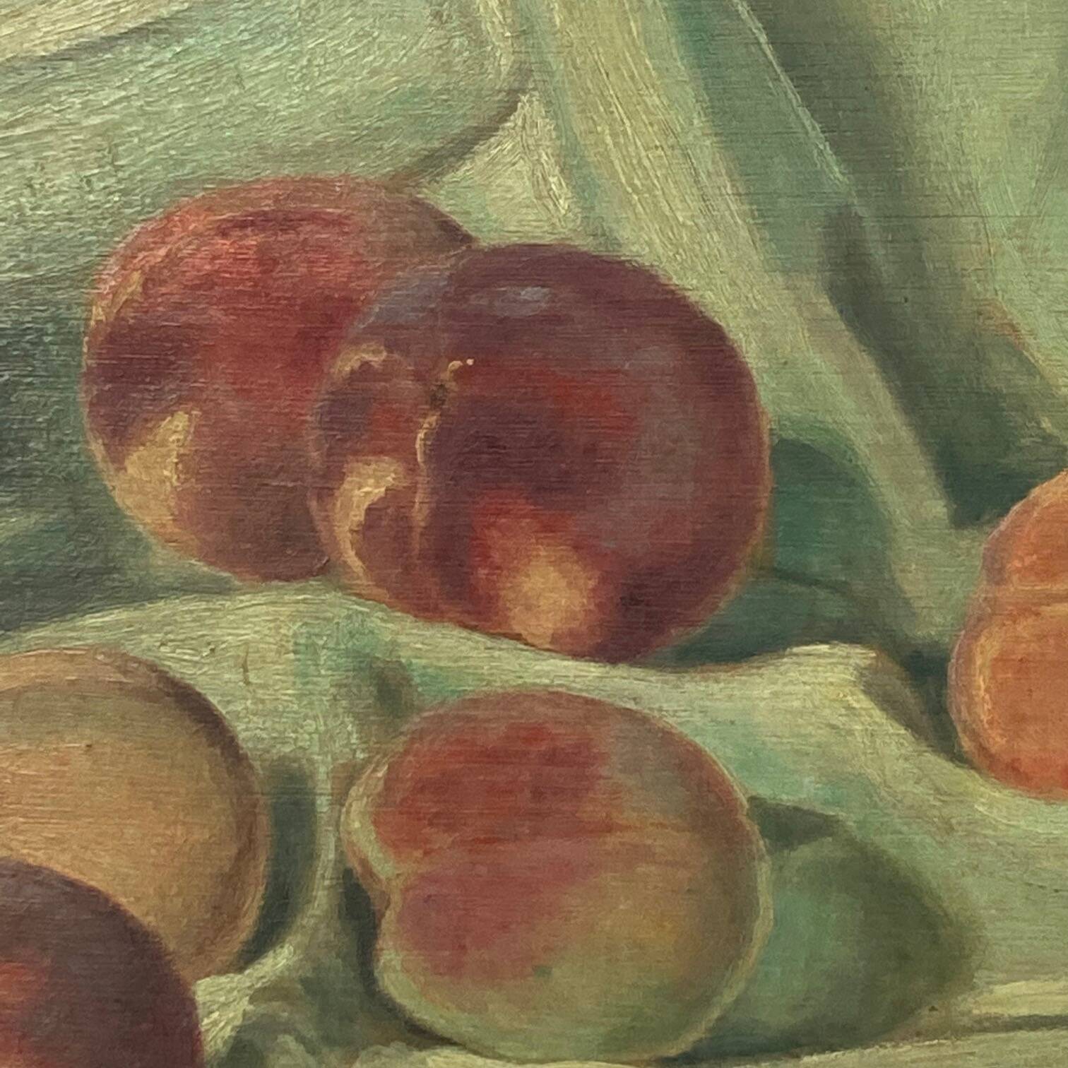 Still life depicting peaches on a cloth
