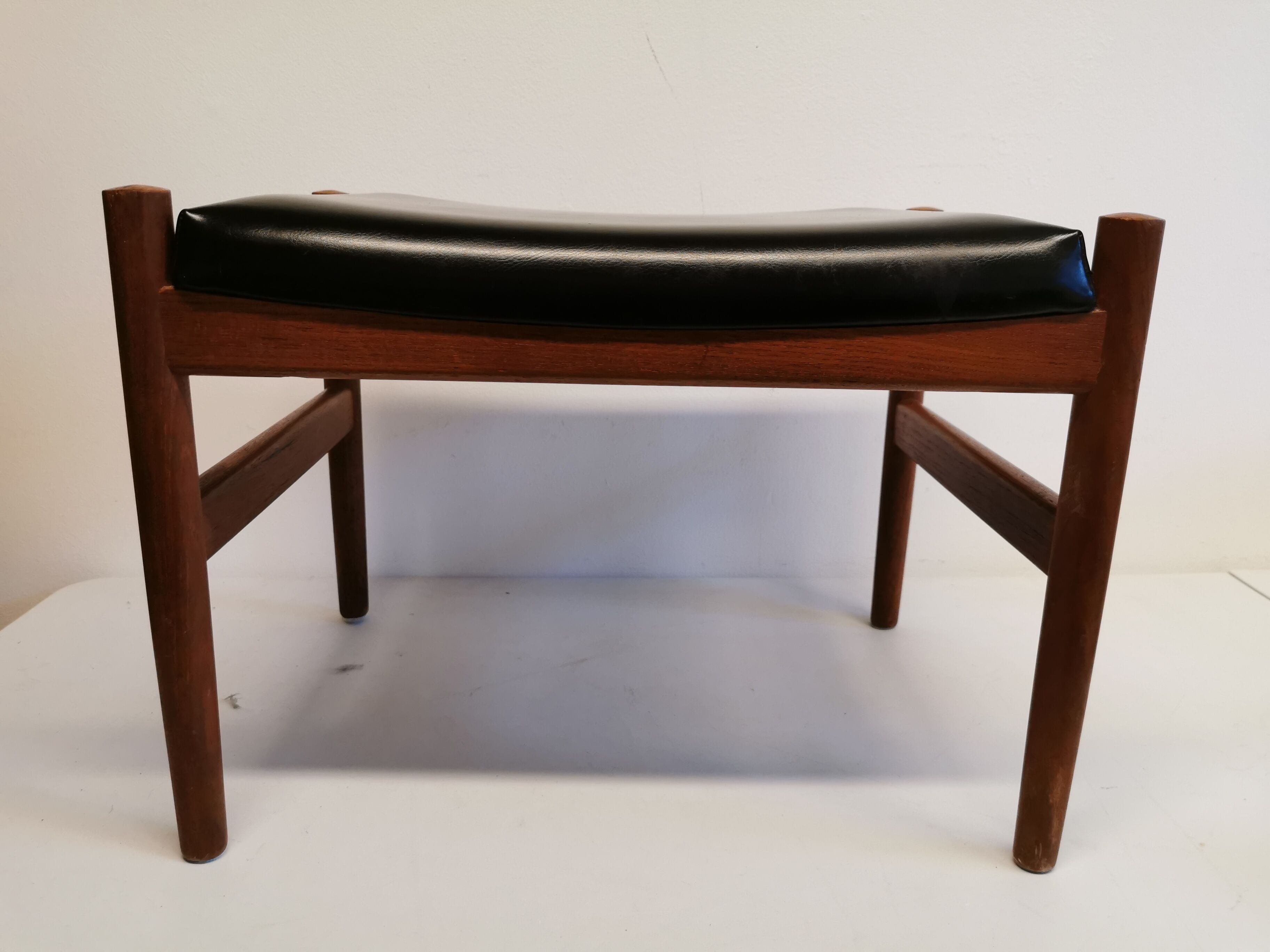 Danish designed footstool, in teak and black skai. Made at Spøttrup furniture factory in the 1960s.