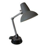 Super Chrome old articulated metal desk lamp on workshop decor base