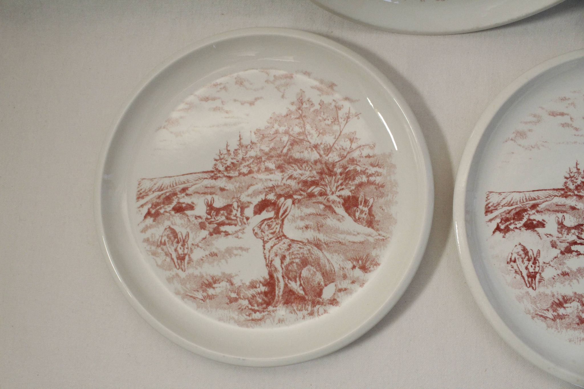 Set of 3 mismatched flat plates - red/burgundy decorations - deer and hare
