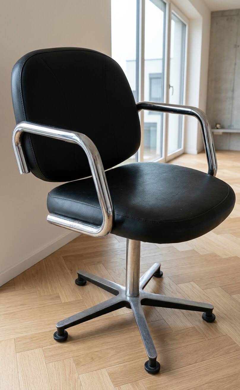Pair of vintage swivel armchairs in metal and black faux leather.