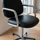 Pair of vintage swivel armchairs in metal and black faux leather.