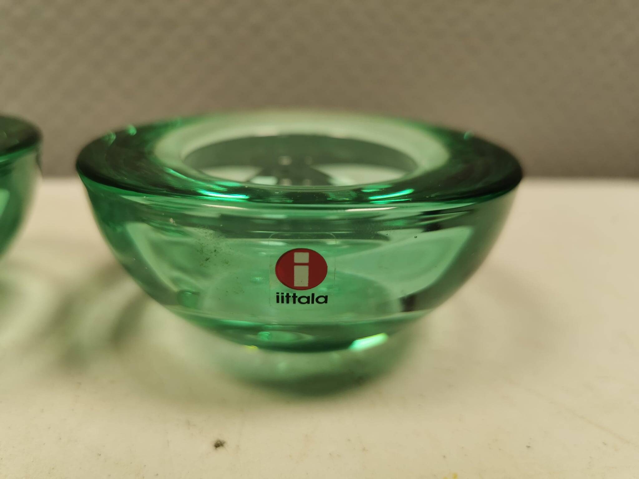 A set of iitalla candle holders in green transparent glass.