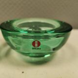 A set of iitalla candle holders in green transparent glass.