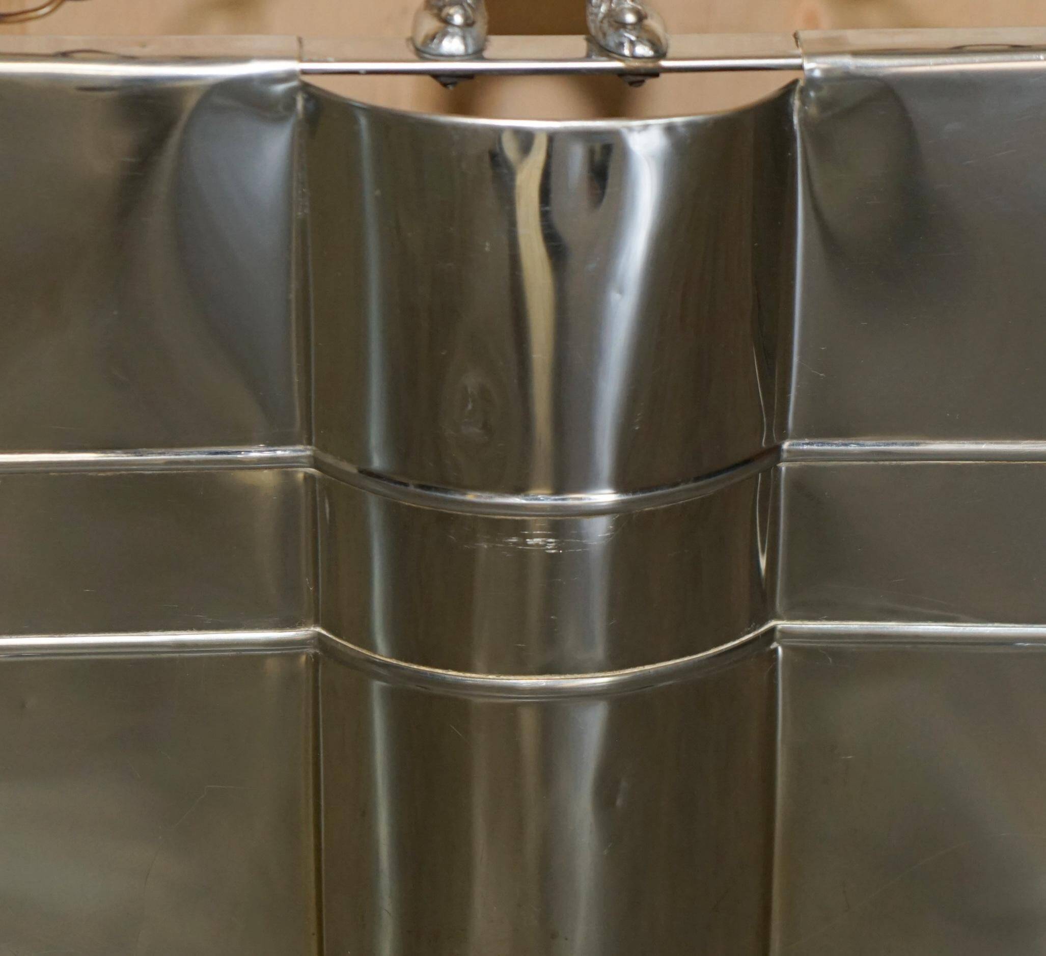 Art Deco fire screen from around 1920 in polished chrome with a bear.